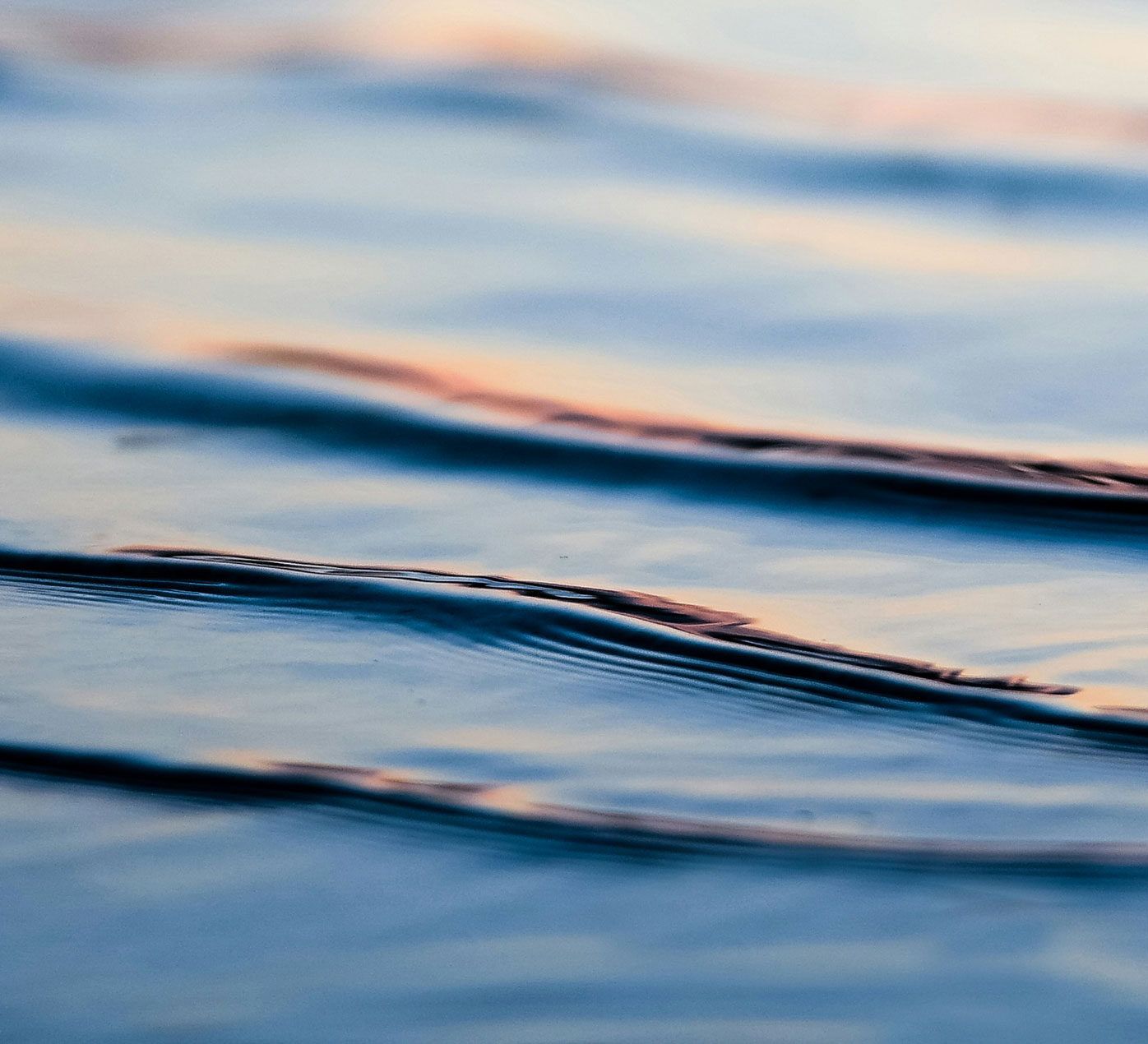 Ripples in water reflecting a sunset
